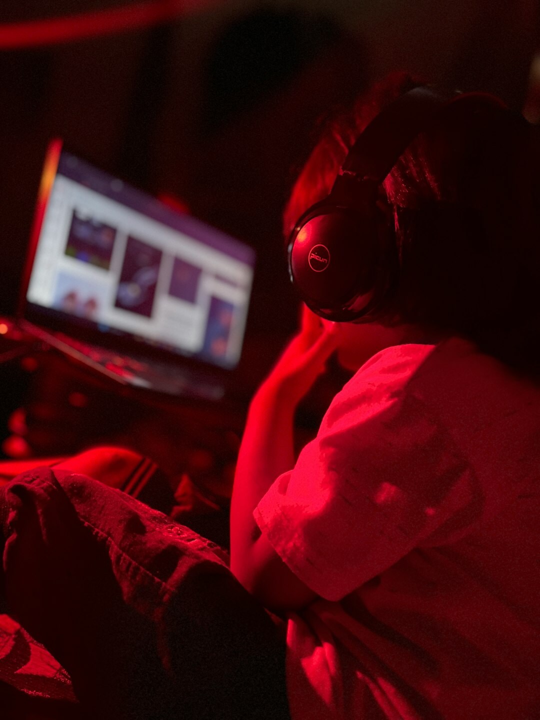 writer typing on laptop in dark room